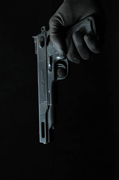 istock Gun and  Hand on a Black Background 187471546