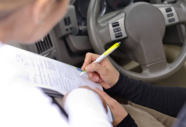 istock Woman drivier signing a legal document 187472056