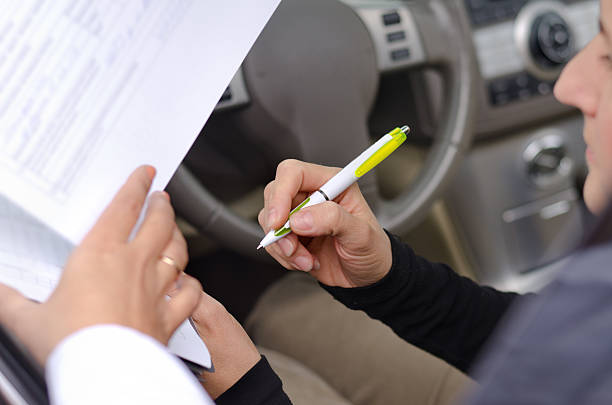 istock Woman driver signing paperwork 187472957