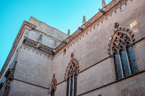 Concept photo of the Basilica of Saints Justus and Pastor, Barcelona. Beautiful urban scenery photography with ornamental wall. Street scene in Catalonia, Spain. High quality picture for wallpaper, article