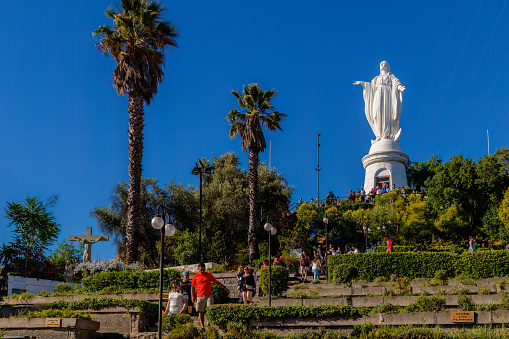 Santiago, Chile, January 6, 2018: Vistors are seen climbing up the hill to see a huge statue of the Virgin Marry at Cerro San Cristóbal (San Cristóbal Hill)