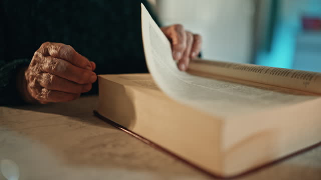 SLO MO Closeup of Elderly Woman Turning Pages while Reading Holy Bible at Home