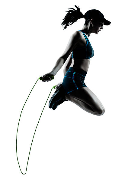 one caucasian woman runner jogger jumping rope in silhouette studio on white background