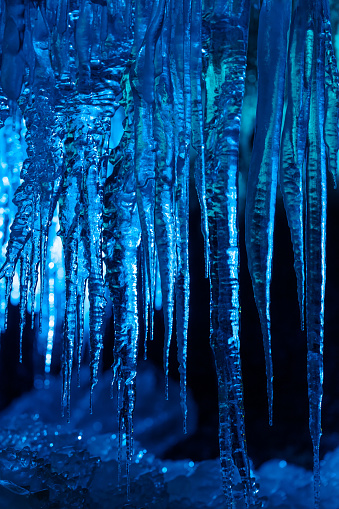 Ice stalactites hang from the ceiling of a limestone solution cave.