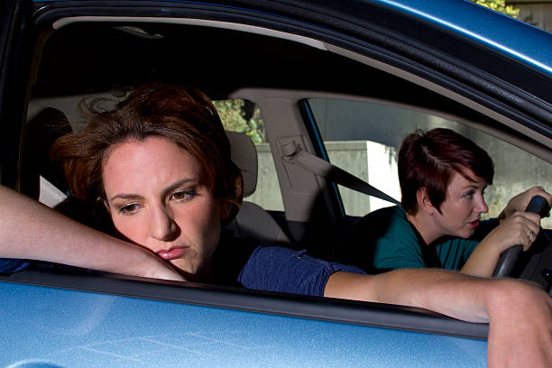 istock Car Sick Passenger Looking Out the Window and a Driver 187478085