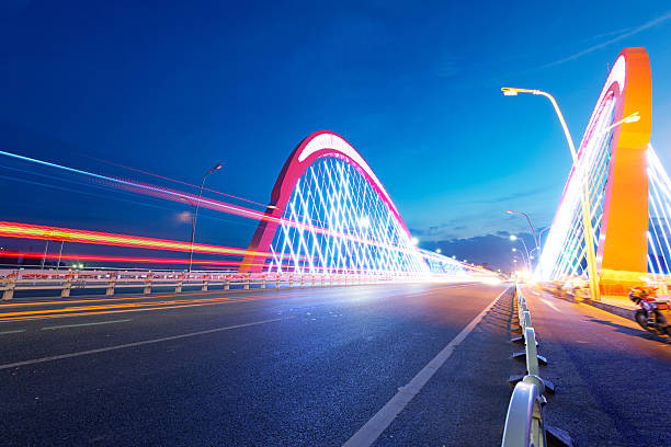 istock cars light trails on the modern bridge at dusk 187478372