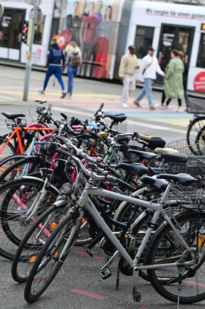 Bicycles in Graz city center with a tram and pedestrians in the background