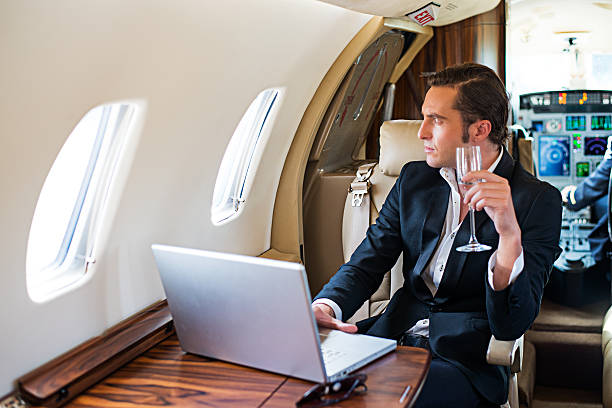 istock Man in business class of private airplane 187479515