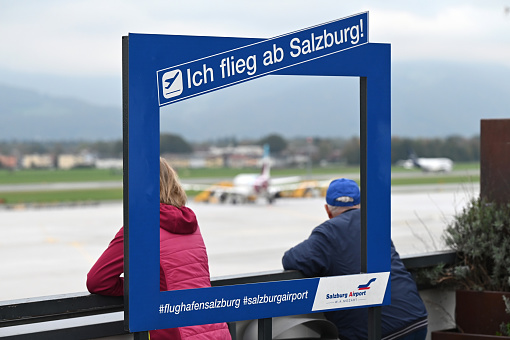 Viewing platform with visitors looking at a plane at the Salzburg Airport in Austria
