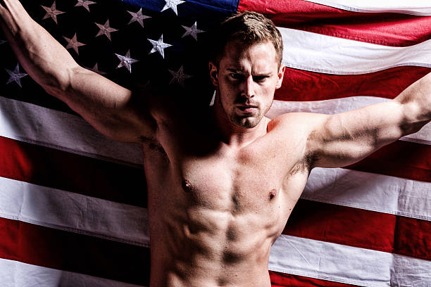 istock Muscular man holding American flag 187479748