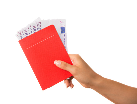 woman hand holding red savings book with some 500 euro  inside, on white background