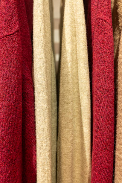 istock wool jerseys hanging in a clothing store 1874802917