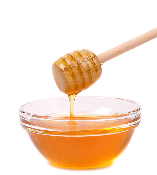 istock Honey dripping from a wooden dipper. 187480364