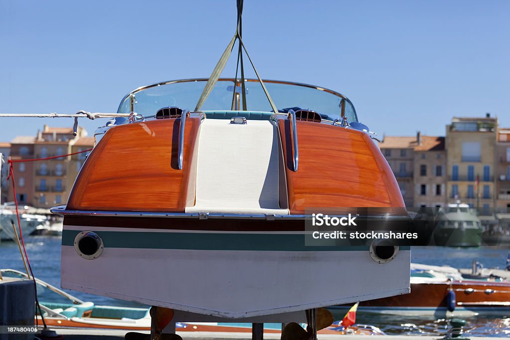 Boat Maintenance Motorboat lifted out of the water to carry out maintenance from the harbour at St Tropez on the French Riviera. Good copy space. Blue Stock Photo