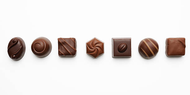 Row of luxury chocolates on white background