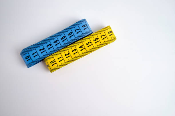 View of the wooden ruler and the millimeter and centimeter scales with red and black numbers. A measuring instrument for craftsmen and do-it-yourselfers