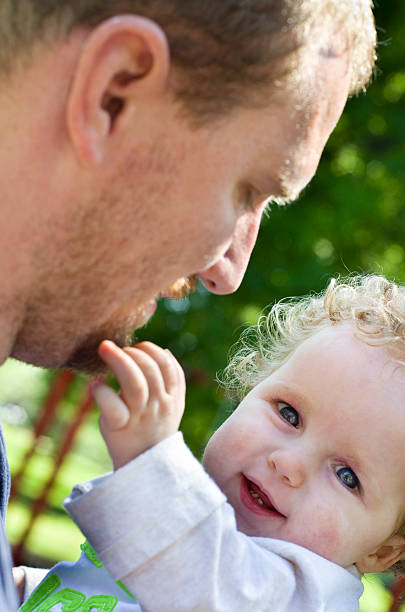 istock baby boy grabs his dad's face 187481537