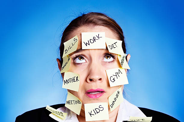 Overworked, overstressed, and overcome woman rolls her eyes An exasperated and overtired woman covered with Post-it reminders for all sorts of tasks rolls her eyes, overcome by how much she has to do. She's seriously over committed. rolling eyes irritation displeased facial expression stock pictures, royalty-free photos & images