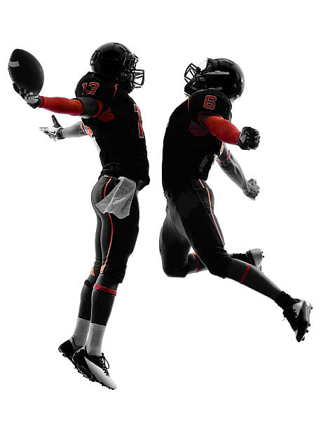 istock two american football players touchdown celebration silhouette 187483749