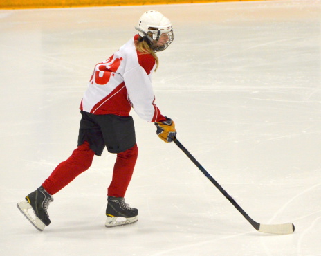 A girl plays hockey.