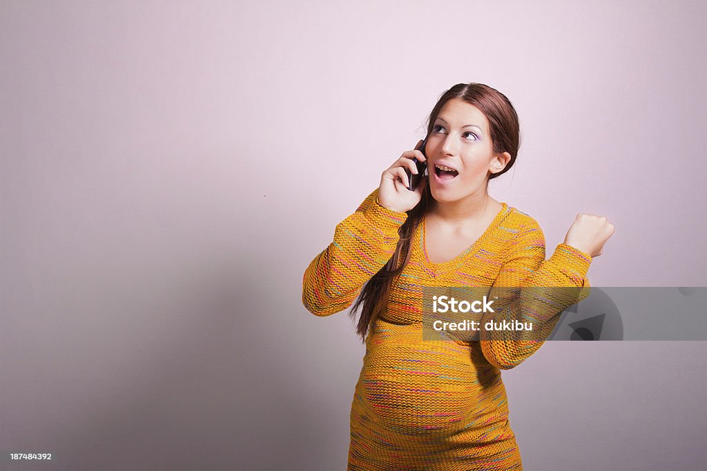 pregnant woman talking on cell phone portrait of pregnant woman talking on cell phone Pregnant Stock Photo