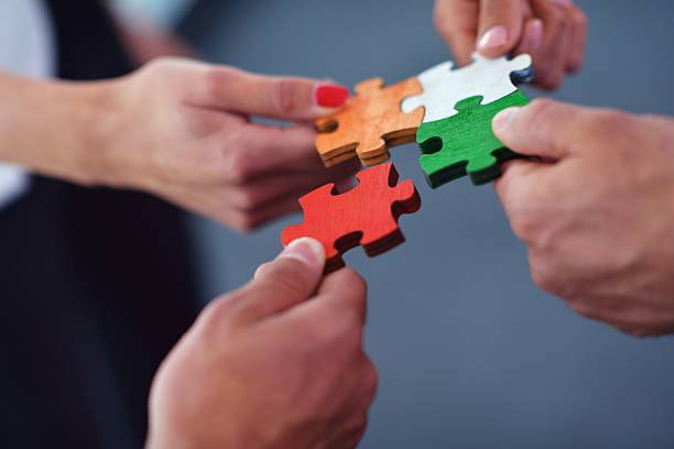 istock Group of business people assembling jigsaw puzzle 187484843