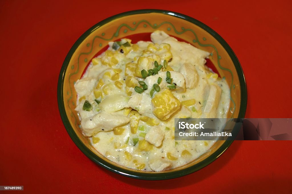 Creamy corn chicken creamy corn chicken on a bowl, red background Bowl Stock Photo