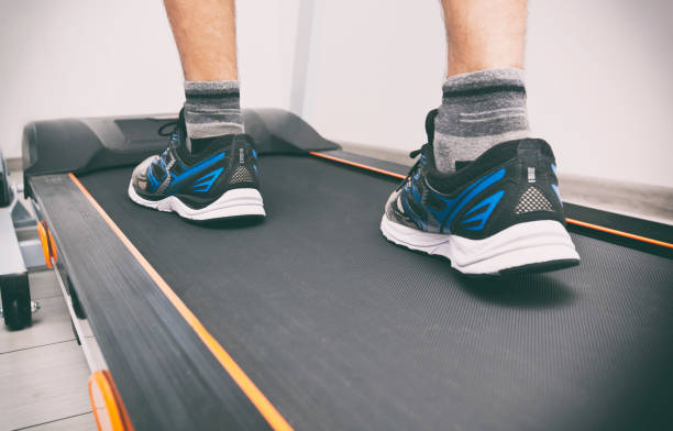 istock The man's legs in sneakers on the treadmill 1874900364