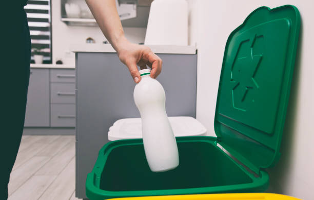 istock The woman throws plastic bottle can to the one of three container for sorting garbage 1874901930