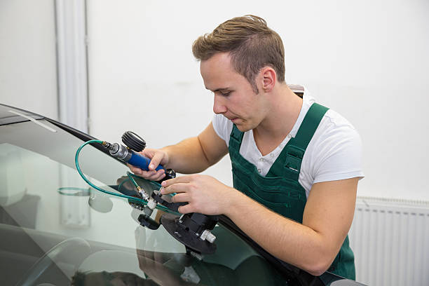 istock Windscreen repair by glazier in garage after stone-chipping damage 187490431