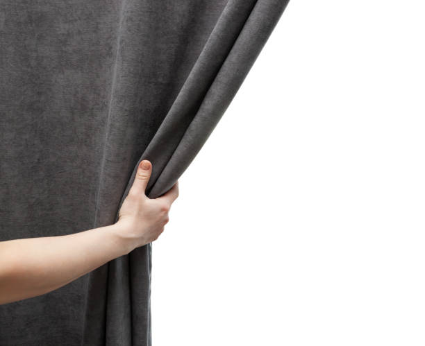 istock The woman's hand open gray curtain 1874910253