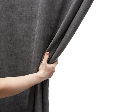 The woman's hand open gray curtain
