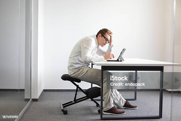 Man Is Bent Over Tabletbad Sitting Posture At Work Stock Photo - Download Image Now