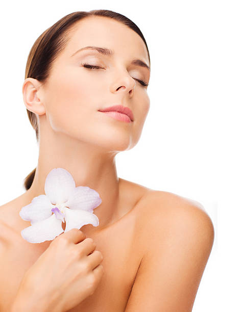 istock relaxed woman with orhid flower 187491465