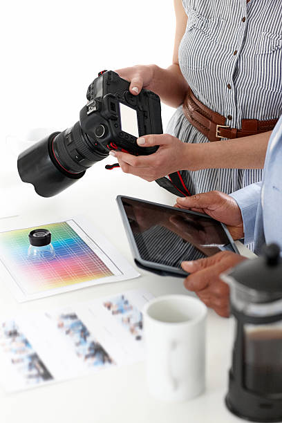 istock Female photographer with a man holding digital tablet 187493976