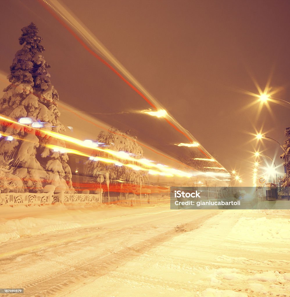 Street with snow Long exposure of front headlights on a road in the night. Highway Stock Photo