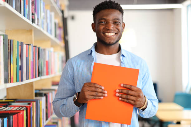 istock A confident and joyful student in the university library, embracing education, knowledge, and the joy of learning. 1874951642