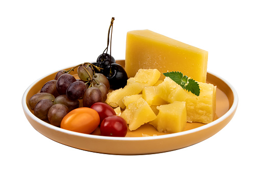Variety of Cheeses on ceramic plates with biscuits and jam also in the photograph.