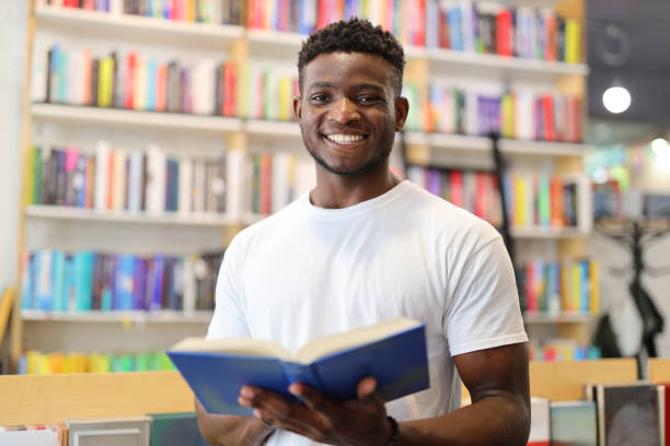 istock A diligent student in a university library, surrounded by books and bookshelves, engaged in academic learning and research. 1874952210