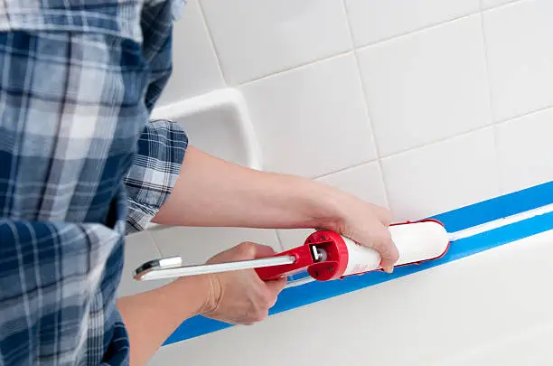 Caulking the bathroom tile.  Please see my portfolio for other home improvement images.