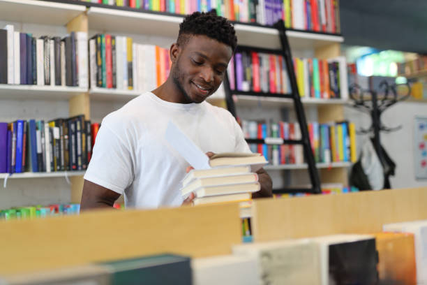 istock A focused student in the university library, surrounded by books, engaged in academic learning and making thoughtful choices from the shelves. 1874952728