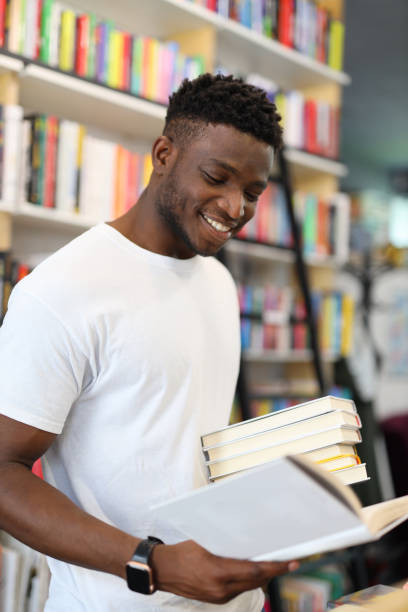 istock A joyful and cheerful student in the university library, surrounded by books, immersed in academic pursuits and displaying happiness. 1874952733