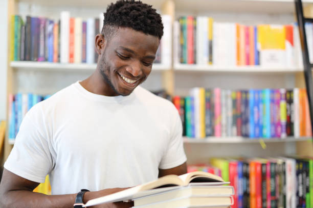 istock A focused student in a university library, surrounded by books, immersed in academic pursuits, and showcasing a commitment to learning. 1874952734