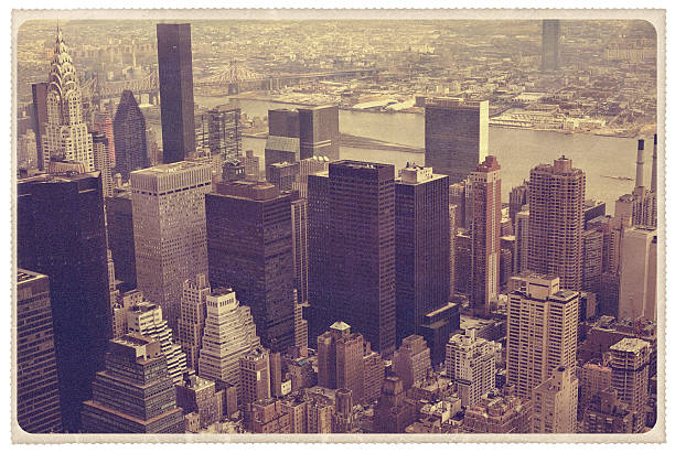 Midtown Manhattan Aerial View - Vintage Postcard Retro-styled postcard of a view from the top of the Empire State Building observation deck. The Chrysler Building is framed in the top left of the cityscape. This was shot on a Kodachrome slide and there is a heavy, natural grain throughout the image -- all artwork is my own...For hundreds of similar vintage postcards from around the world, click the banner below. east river new york city photos stock pictures, royalty-free photos & images