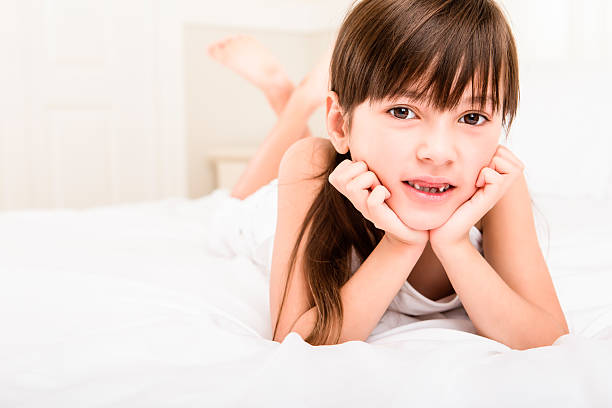 istock Young girl laying in bed 187495337