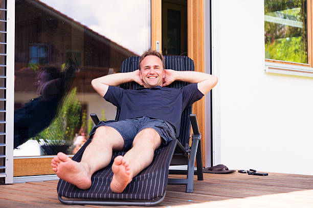 istock adult man relaxing on patio 187495716