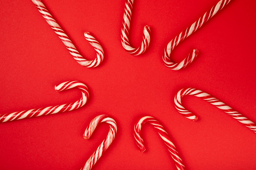 Christmas candy canes on  background. Holiday greeting card. Concept for Christmas and New Year holidays. Winter. Flatlay, top view, copy space.