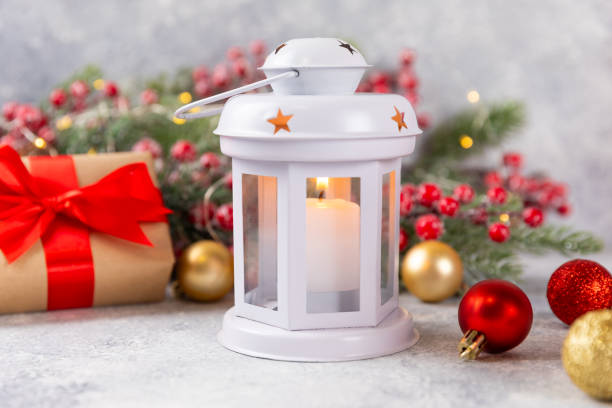 Christmas lantern with Christmas tree branch. Winter decoration background. Lantern with candles and Christmas decorations on a wooden background. New Year and Christmas concept.Banner. Copy Space.
