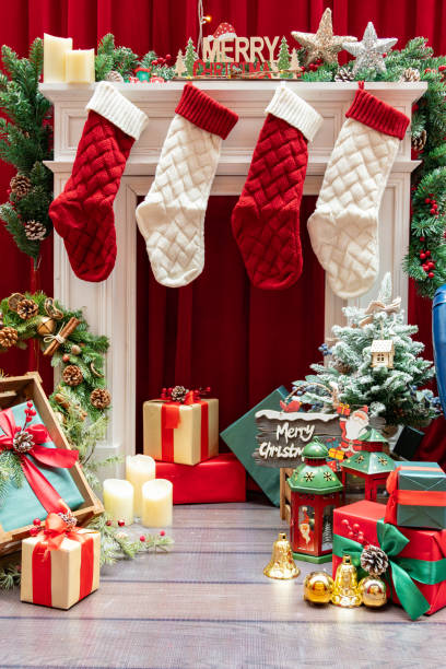 istock Christmas stockings and present boxes and decorations at vertical composition 1874965002