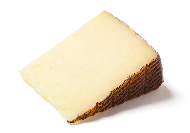 Manchego Cheese Wedge on White Background Manchego is a semi-hard sheep's milk cheese from Spain. machego stock pictures, royalty-free photos & images